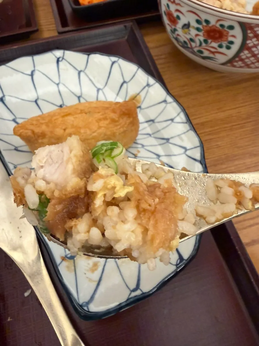 A piece of katsu don being picked up