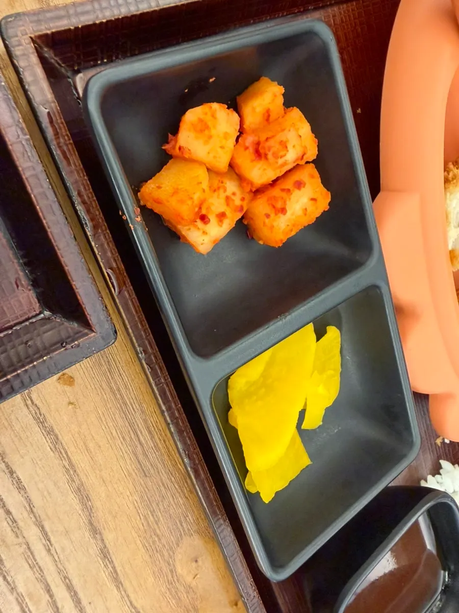 A piece of cheese tonkatsu being picked up