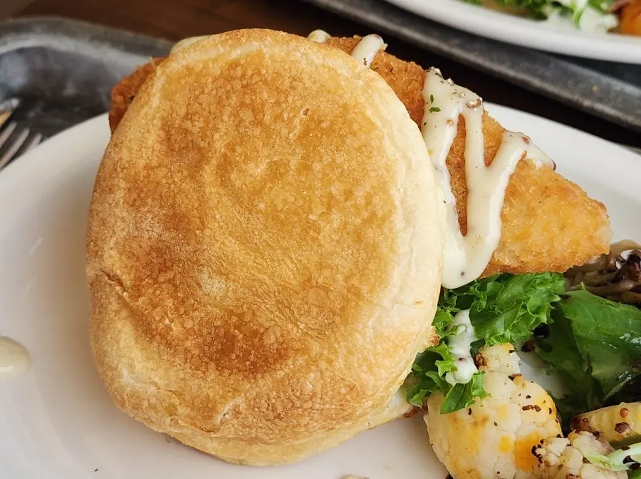 Cross-section of the fish cutlet sandwich with tartar sauce