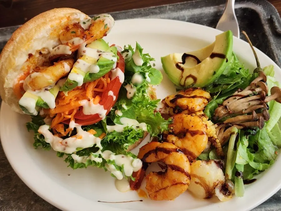 Shrimp avocado sandwich plate packed full inside
