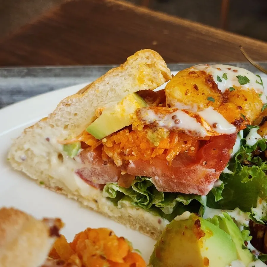 Cross-section of the sandwich showing slaw and tomato