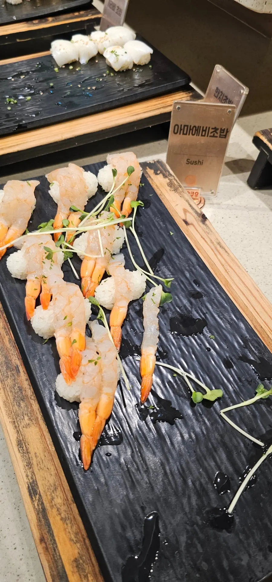 A plate holding egg shrimp sushi