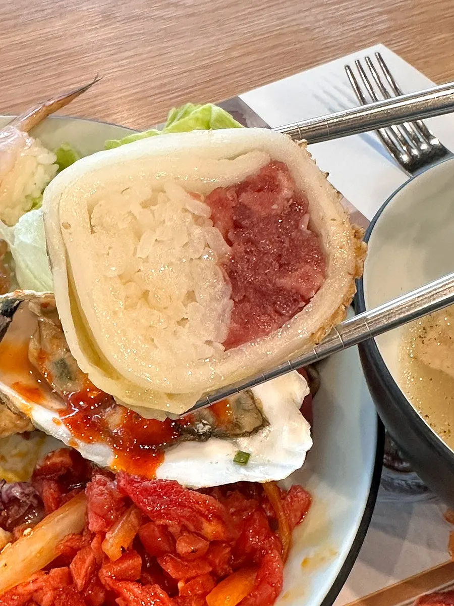 A plate of aged kimchi yukhoe roll