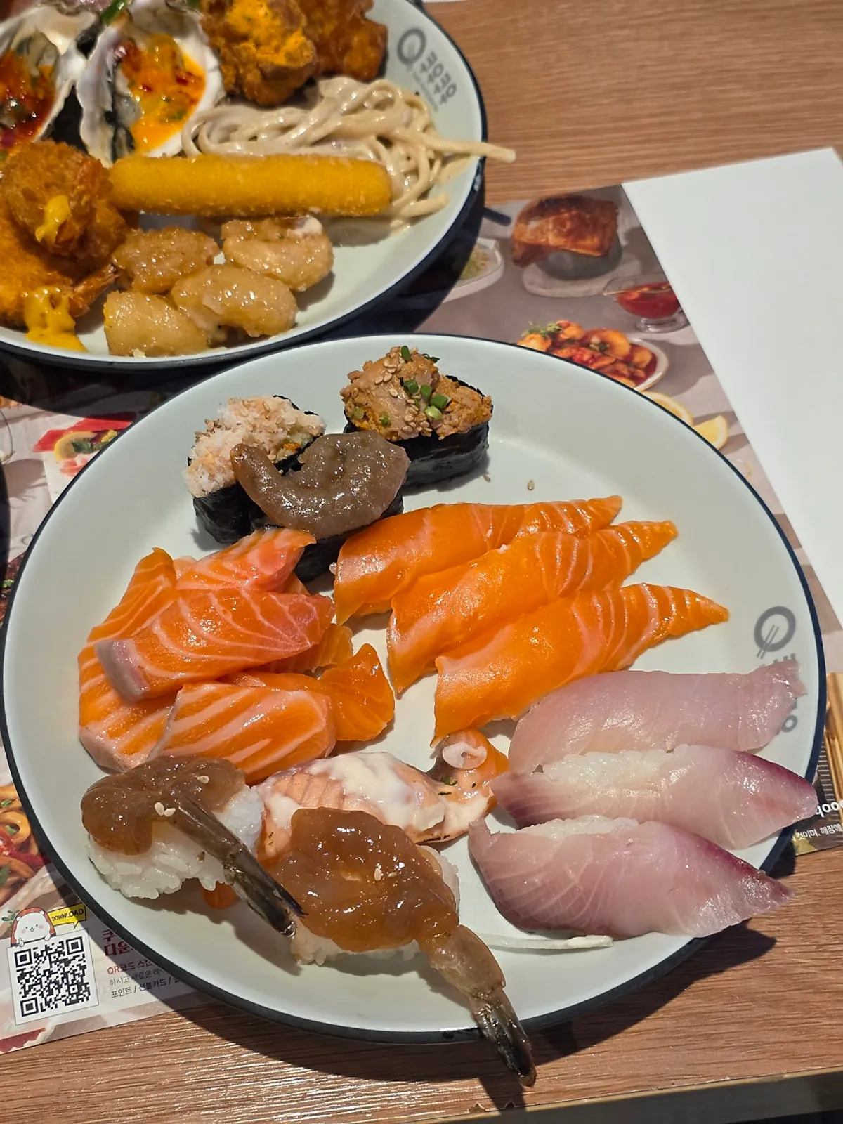 Plate with raw salmon and soy-marinated shrimp sushi