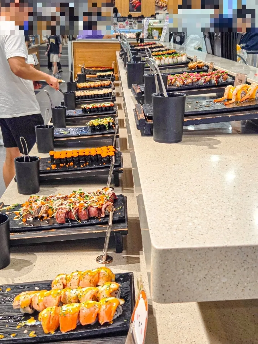 Inside the sushi buffet with many family diners