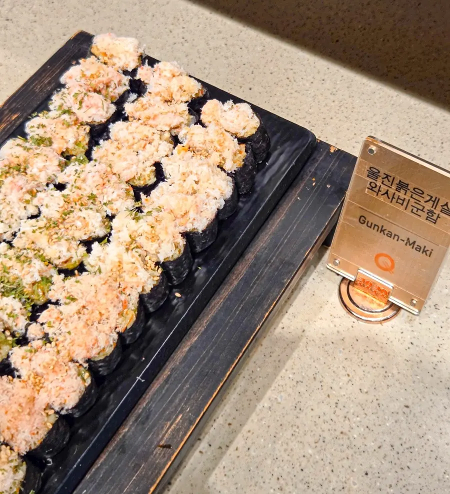 Raw fish sushi and rolls displayed at the counter