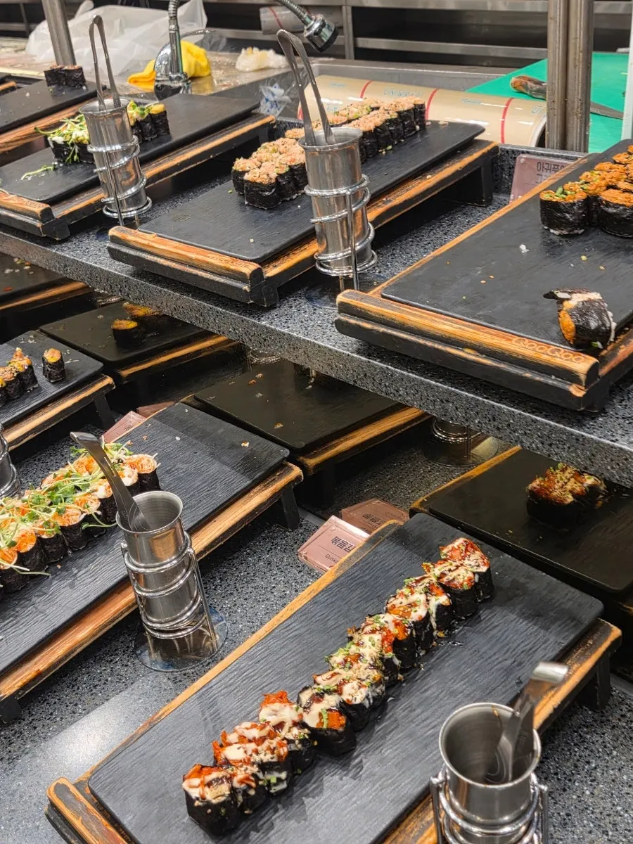 Display case of white fish sushi and gunkan