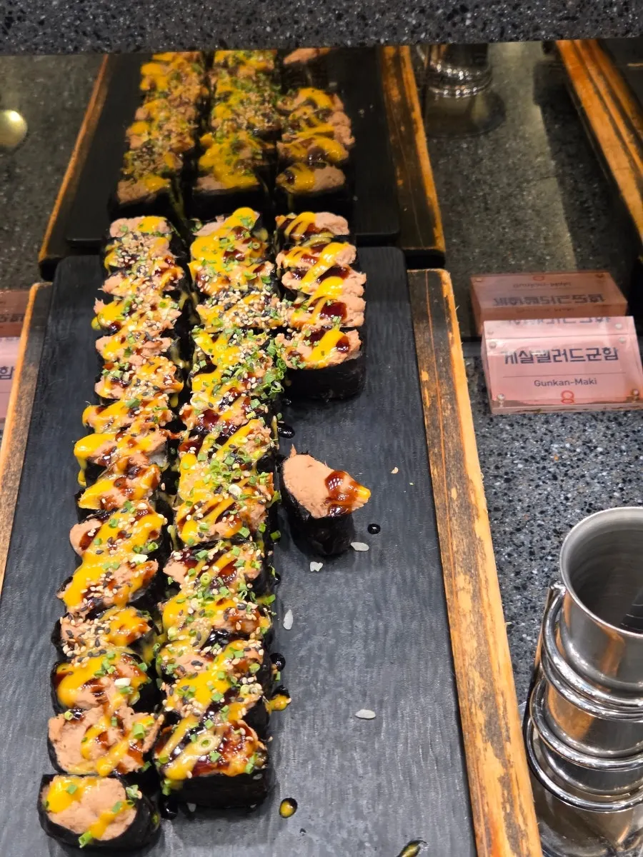 A plate of sushi served with salad