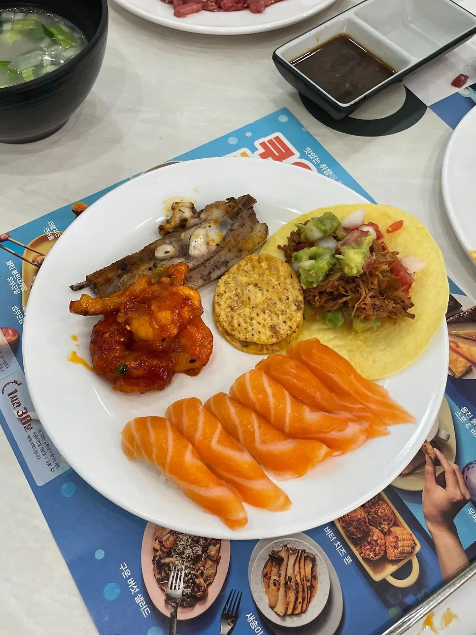 A plate of assorted sushi including salmon and rolls