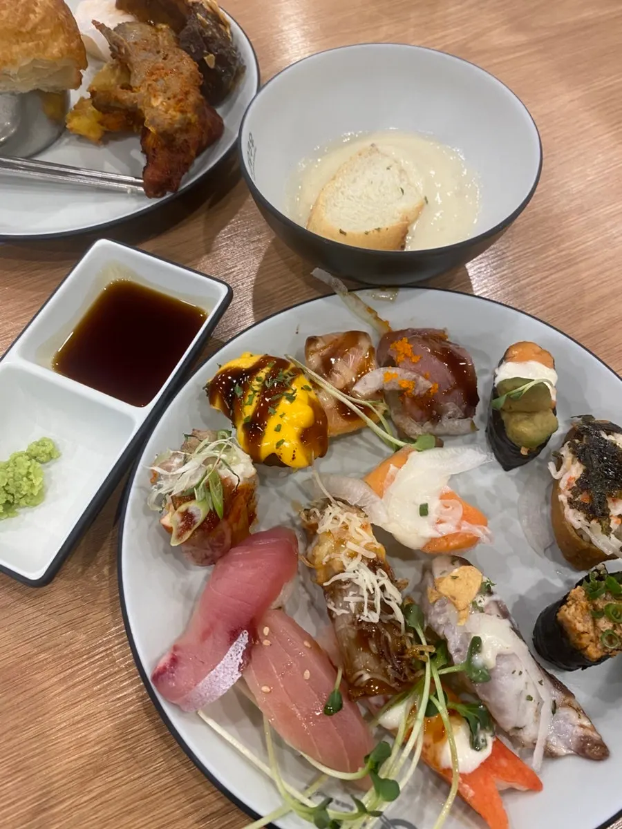 Second plate piled with sushi and California rolls
