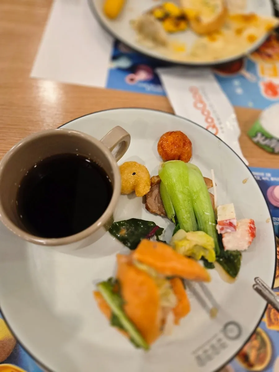 Plate loaded with sushi, meat and dessert