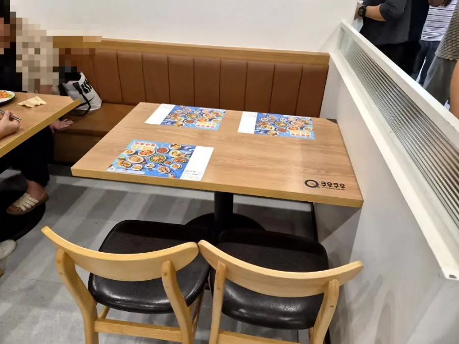 The spacious wood-toned dining hall at Kuu Kuu Nowon Branch