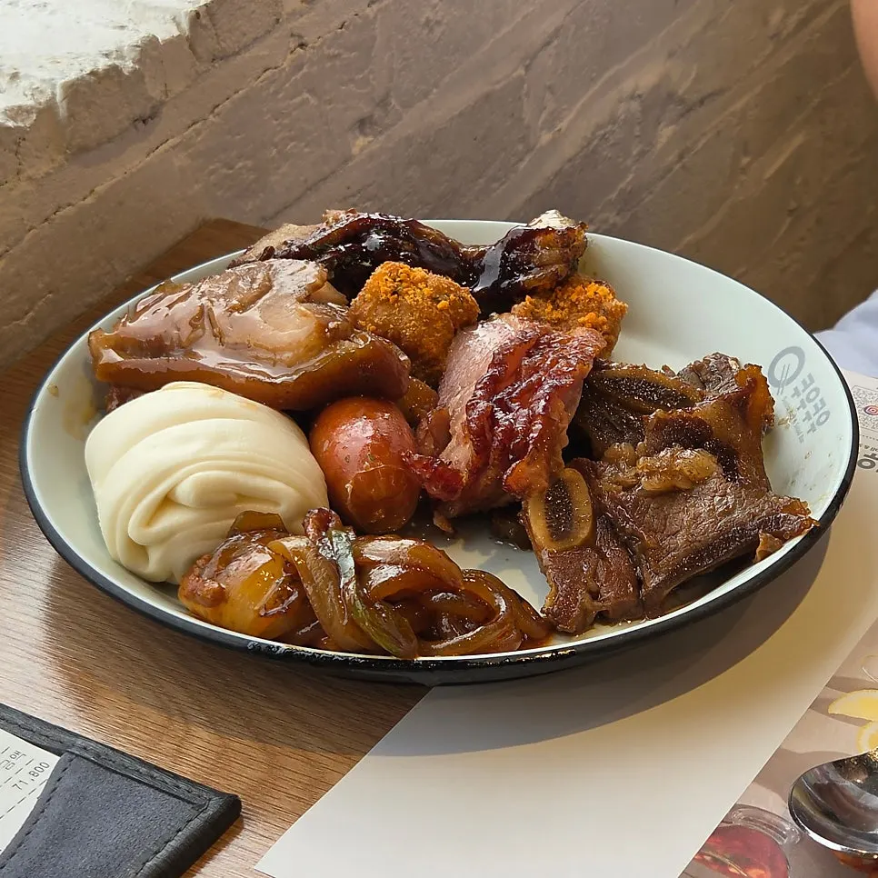 Plate with clam soup and other cooked dishes