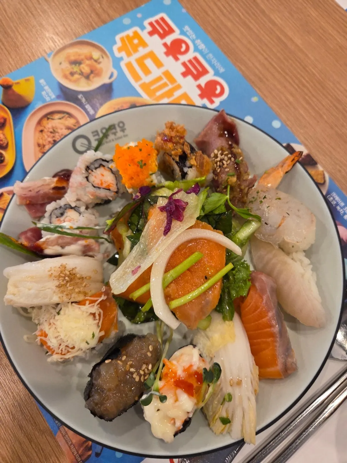 First plate loaded with a variety of sushi