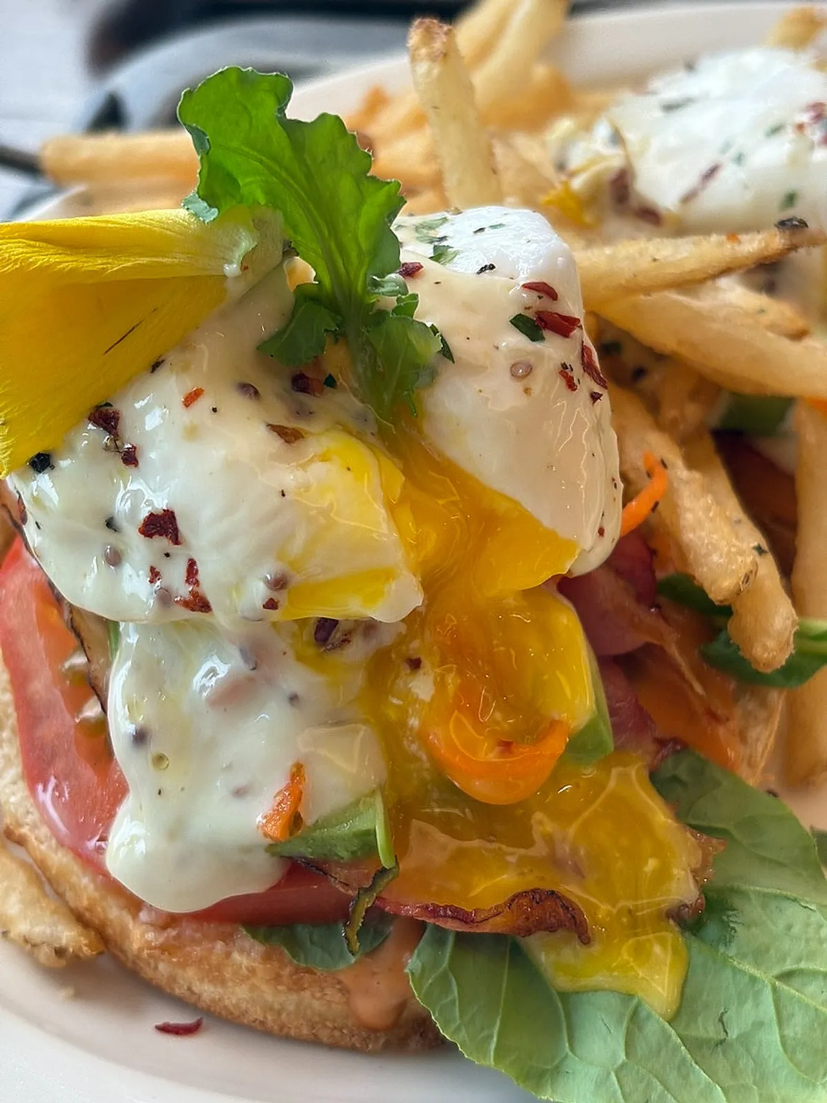 Truffle BLT open sandwich topped with edible flowers