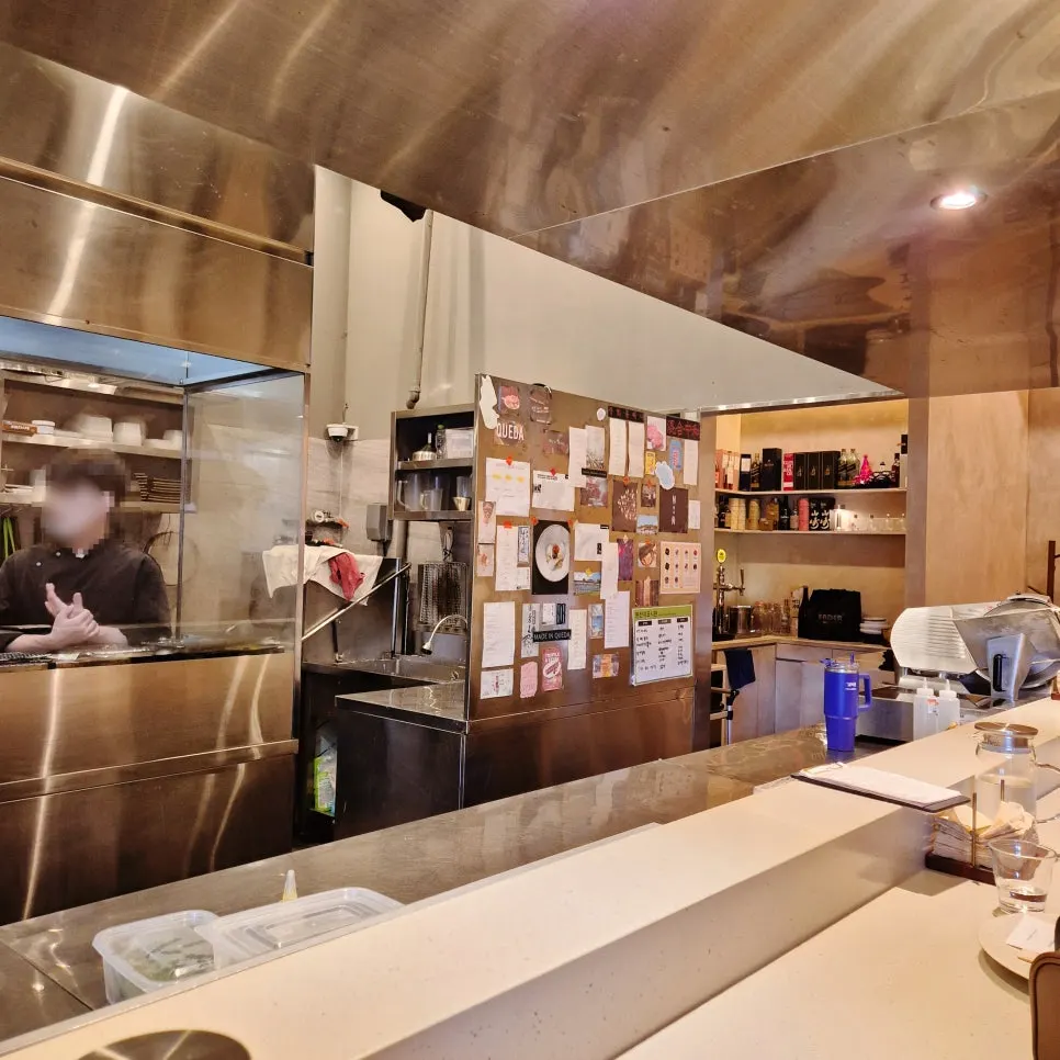 View of Kkweda's open kitchen from the bar seating