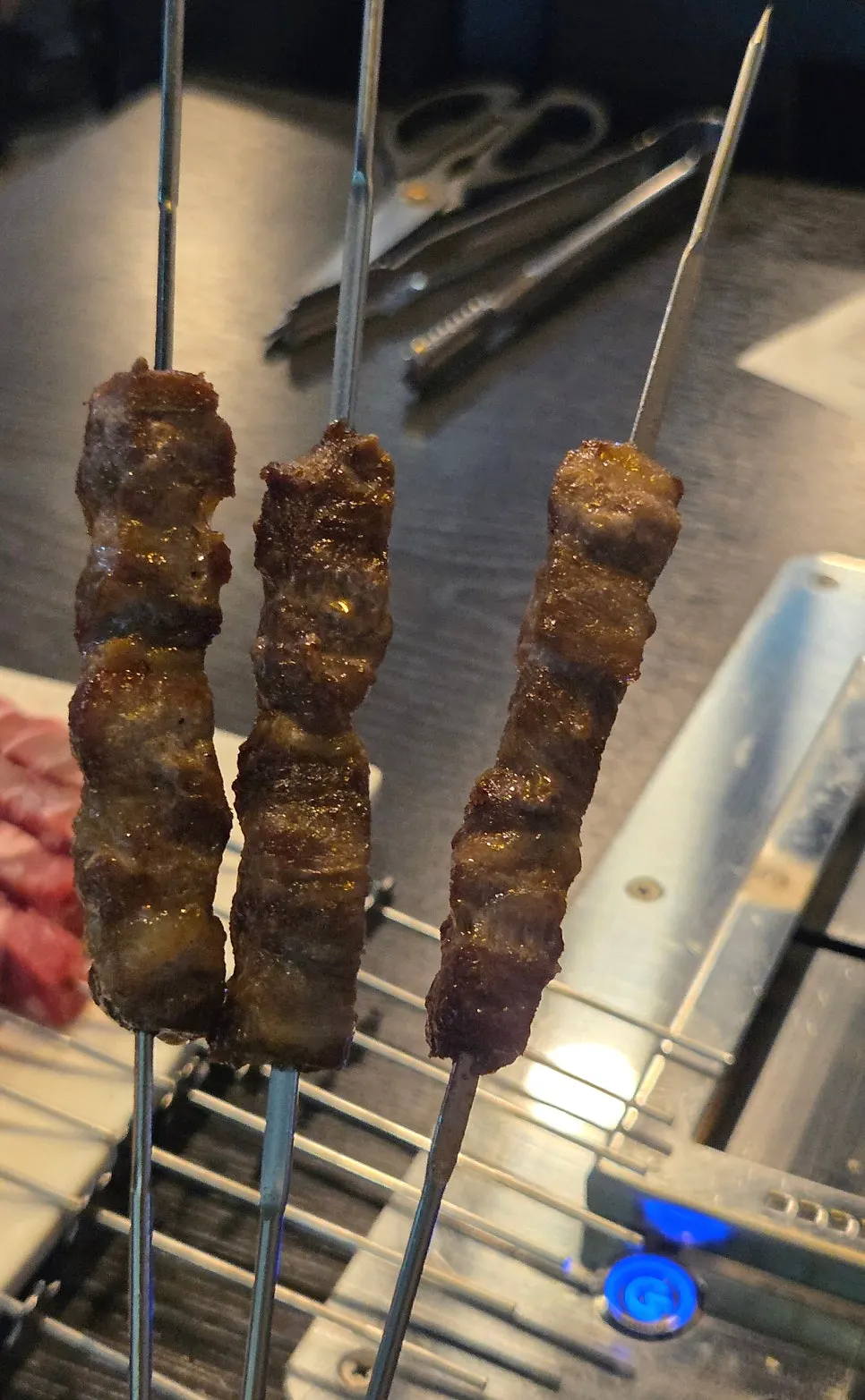Lamb skewers grilling over charcoal
