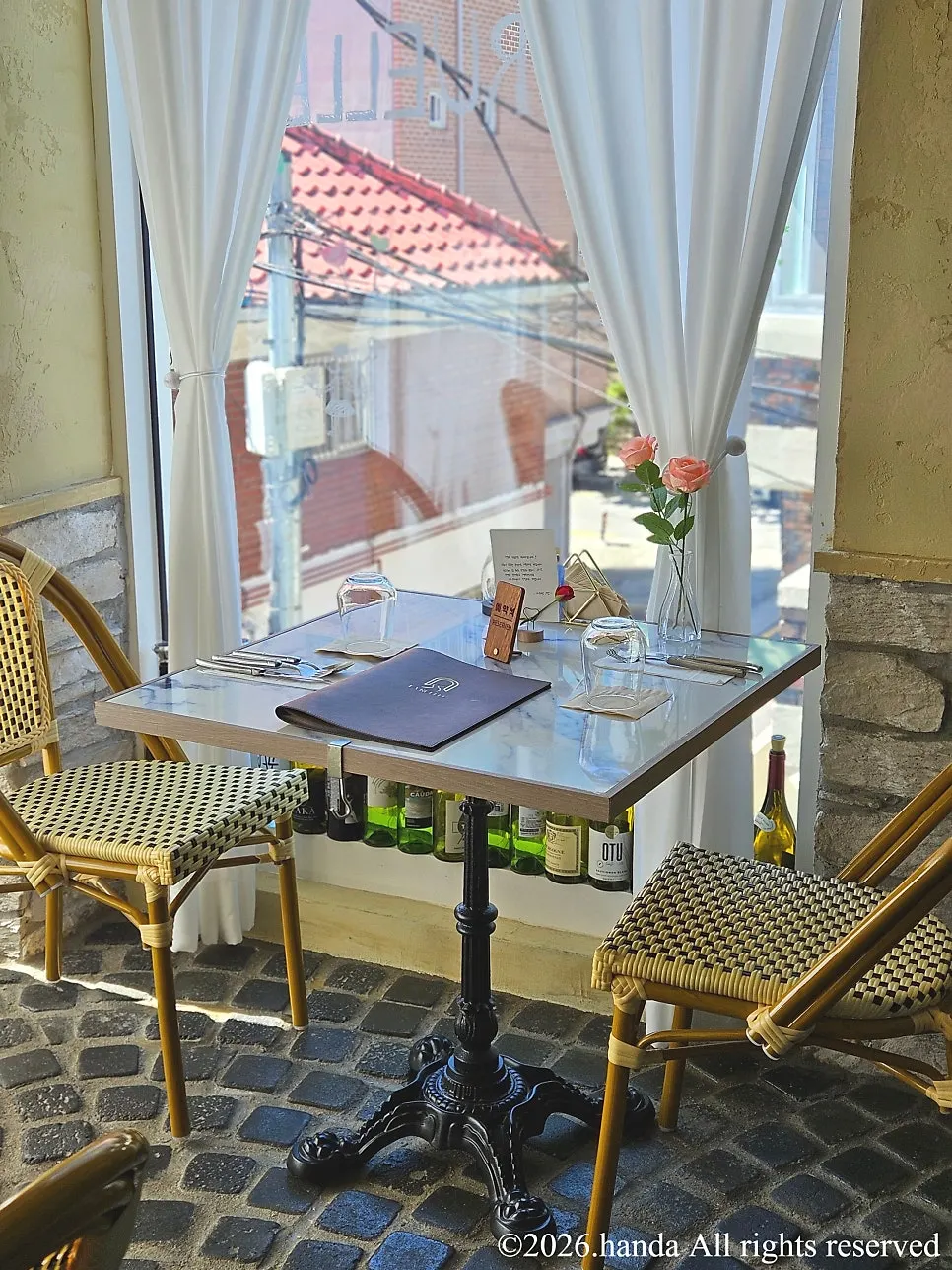 Interior of LA RUELLE with tiled floor and tables