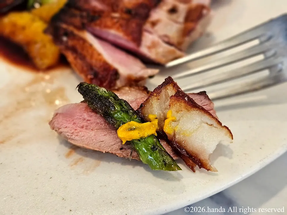 Duck dish served with roasted vegetables and carrot purée