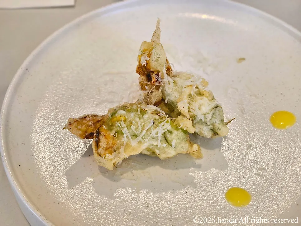 A plate of fried zucchini flower with ricotta cheese