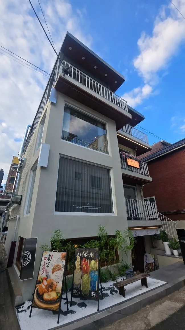 LA RUELLE's building exterior with white facade and large glass window