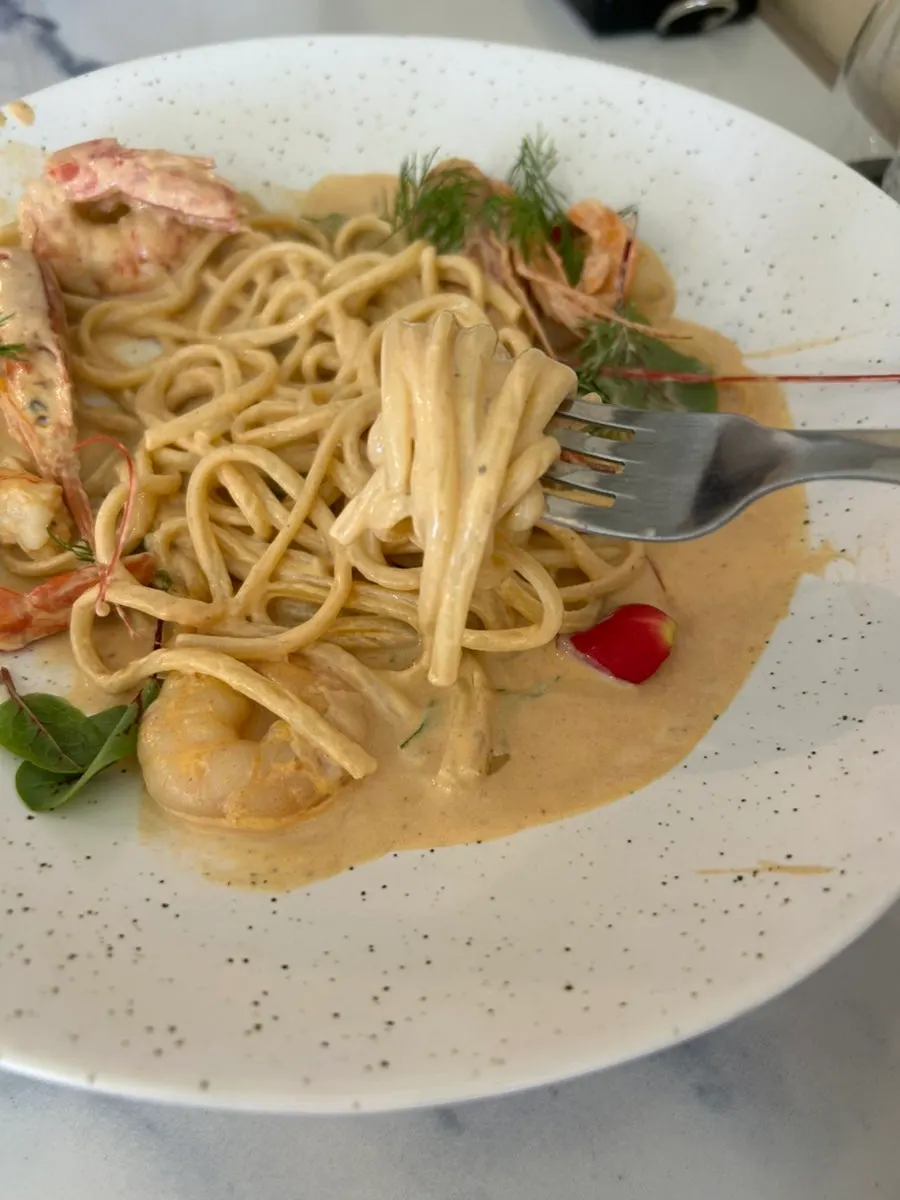 Close-up of bisque pasta with shrimp and rich sauce