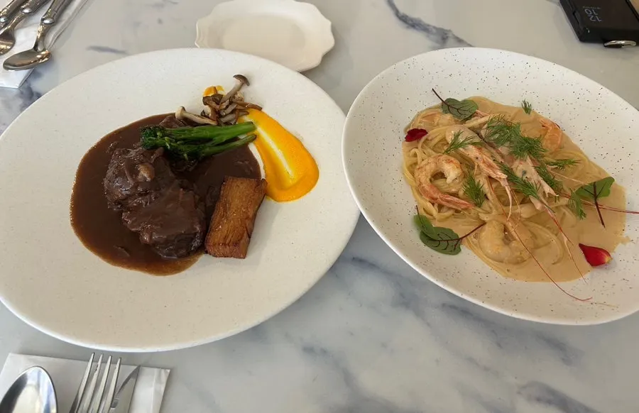 Table set with both beef bourguignon and bisque pasta