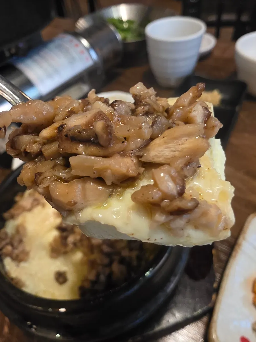 Cross-section of truffle egg custard topped with chopped shiitake mushroom