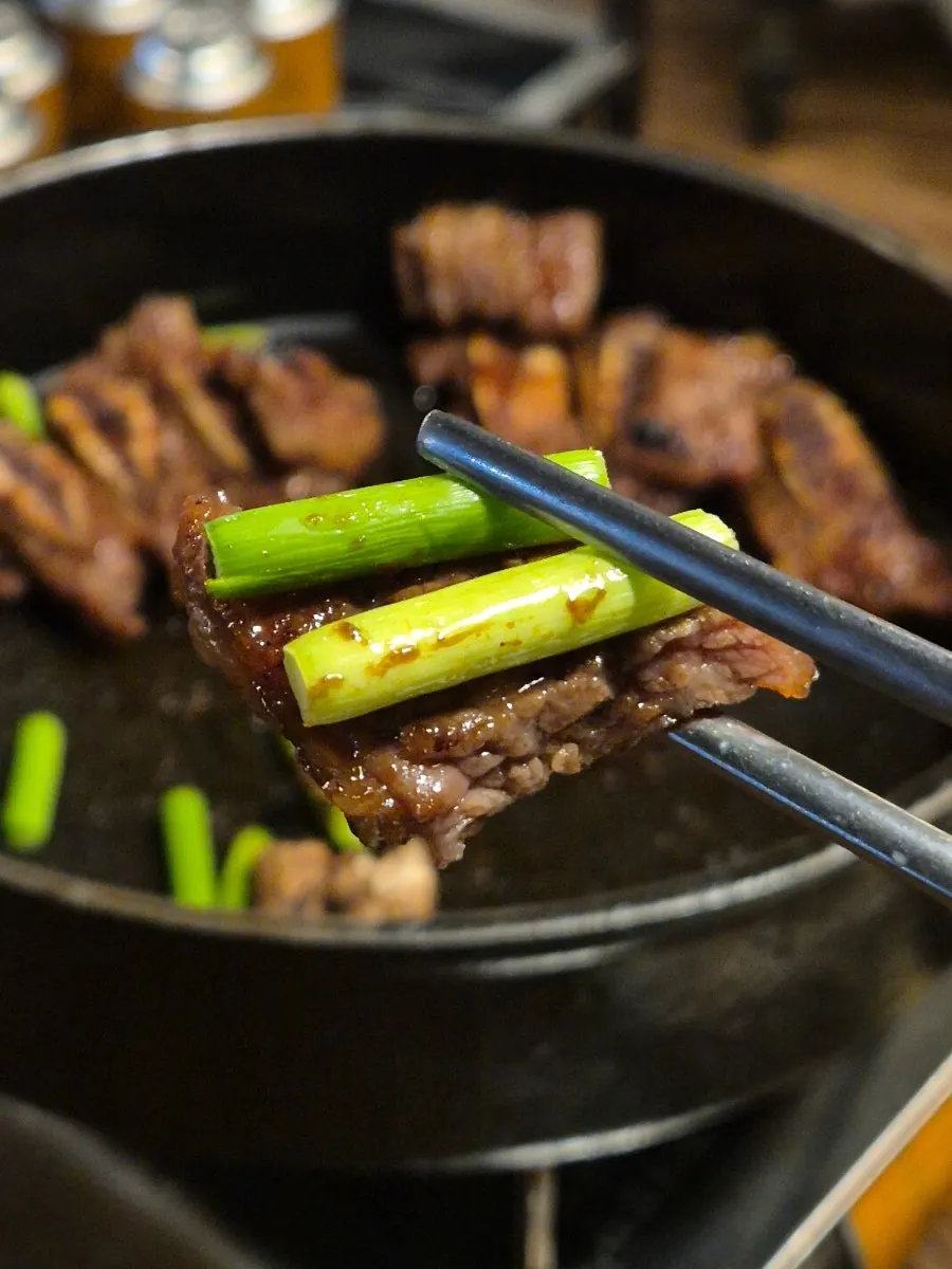 Staff grilling the marinated beef
