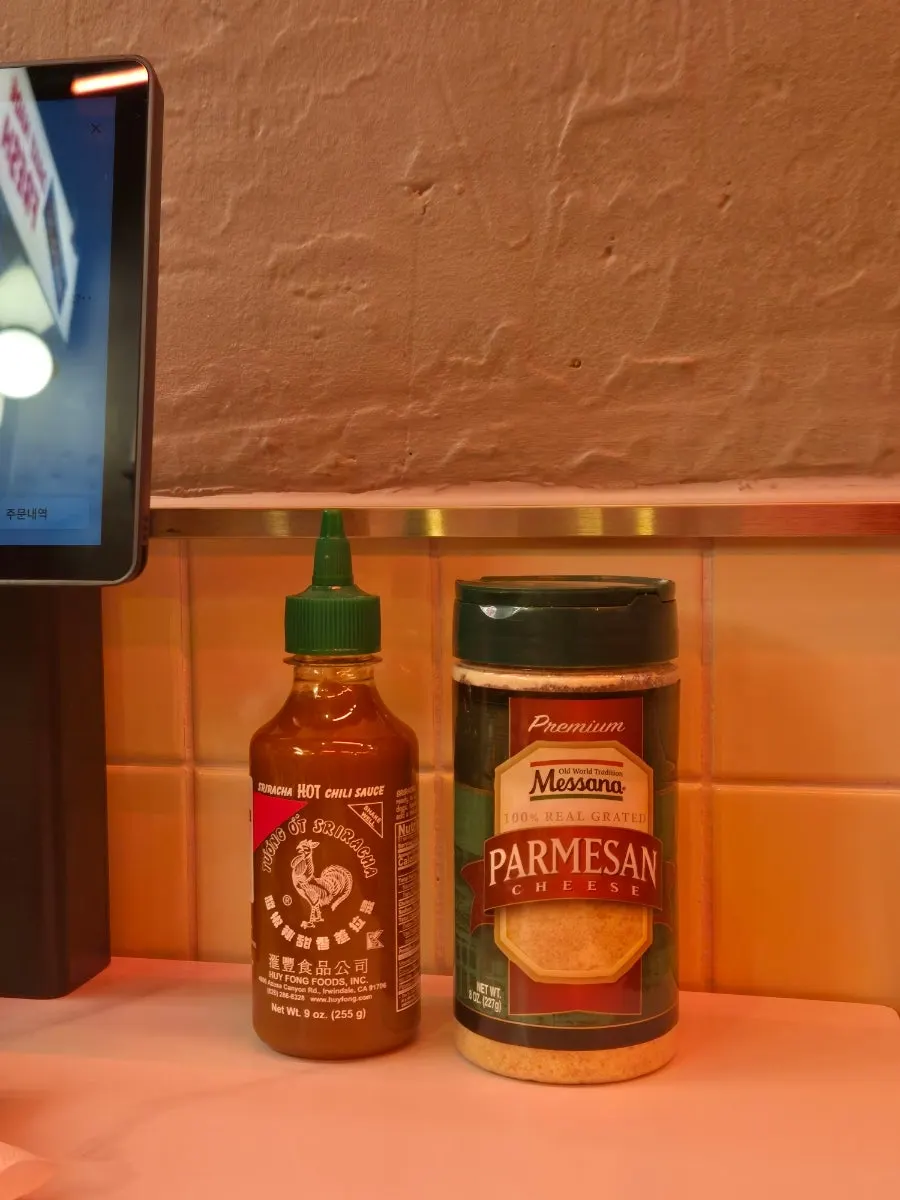 Hot sauce and parmesan cheese served with the coleslaw