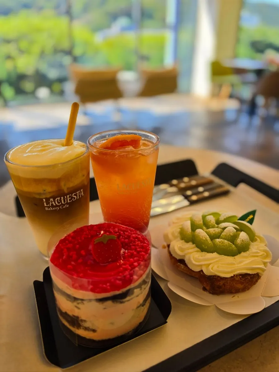 Desserts and drinks at a sunlit window seat