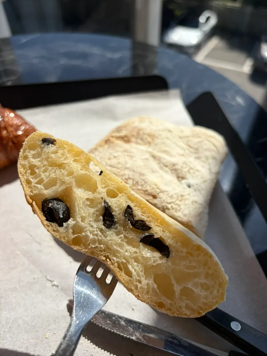 A piece of plain olive ciabatta