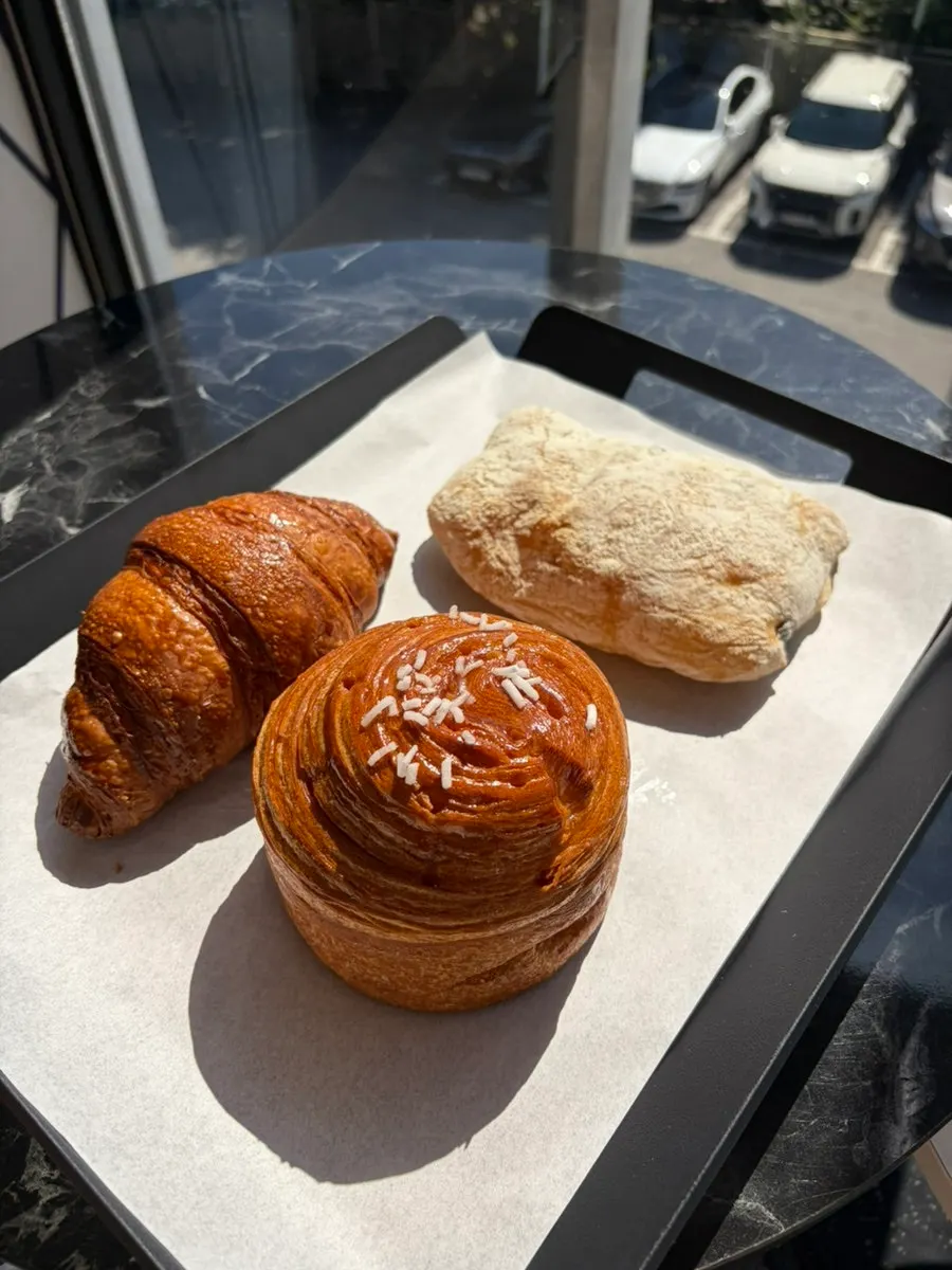 Crispy croissant and coffee on the table