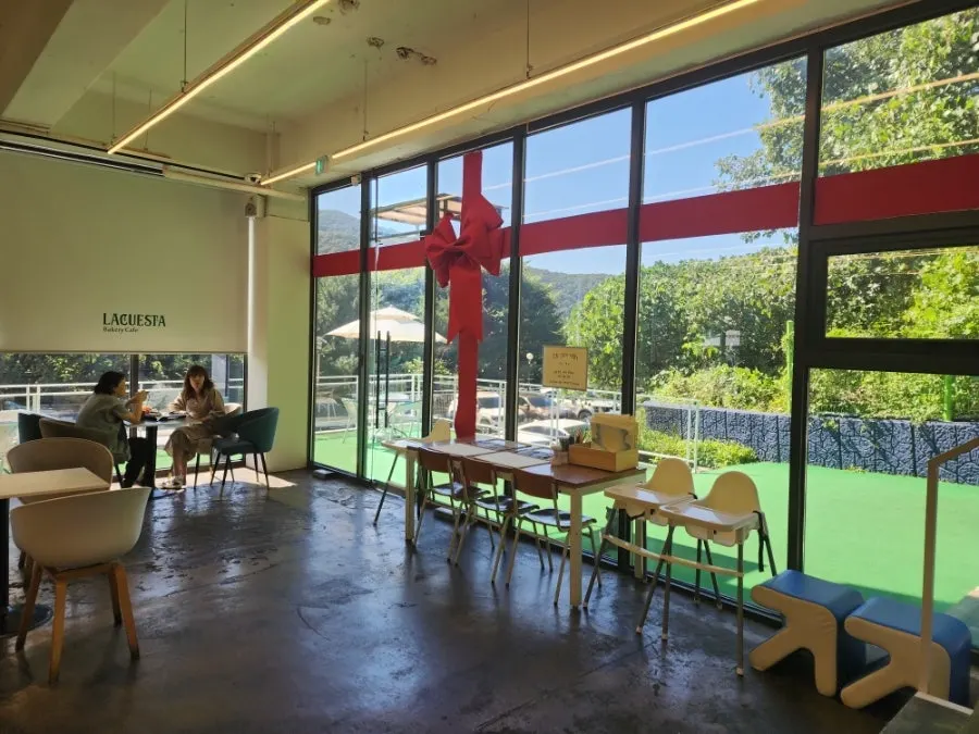 Interior of La Cuesta with a mountain ridge visible through the large windows