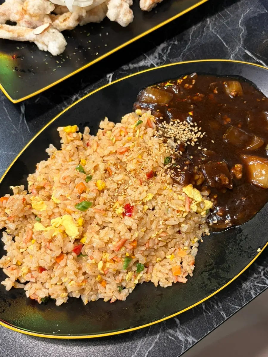 Table spread of tangsuyuk, jjamppong, and fried rice