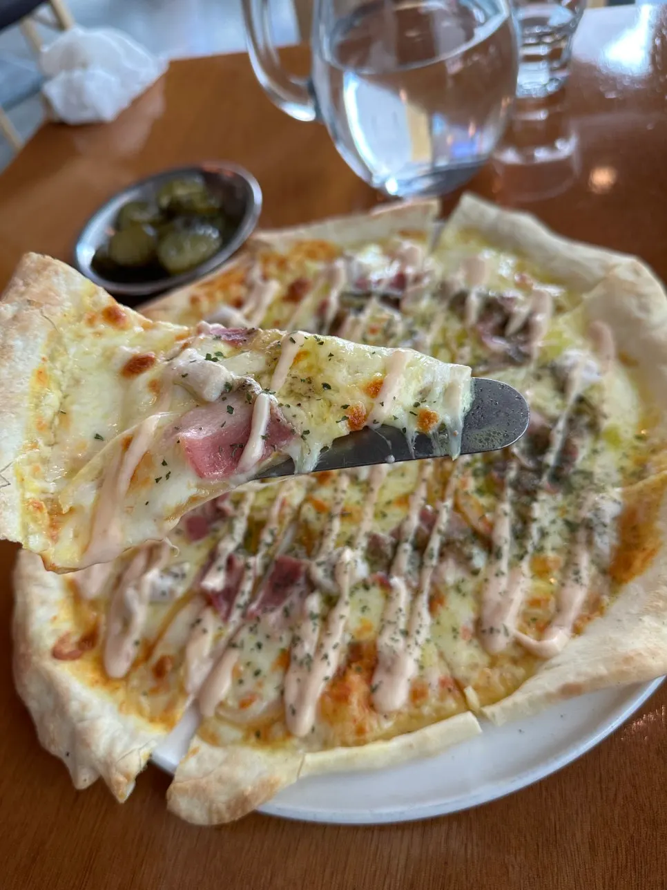 Thin-crust pizza topped with cheese and sauce