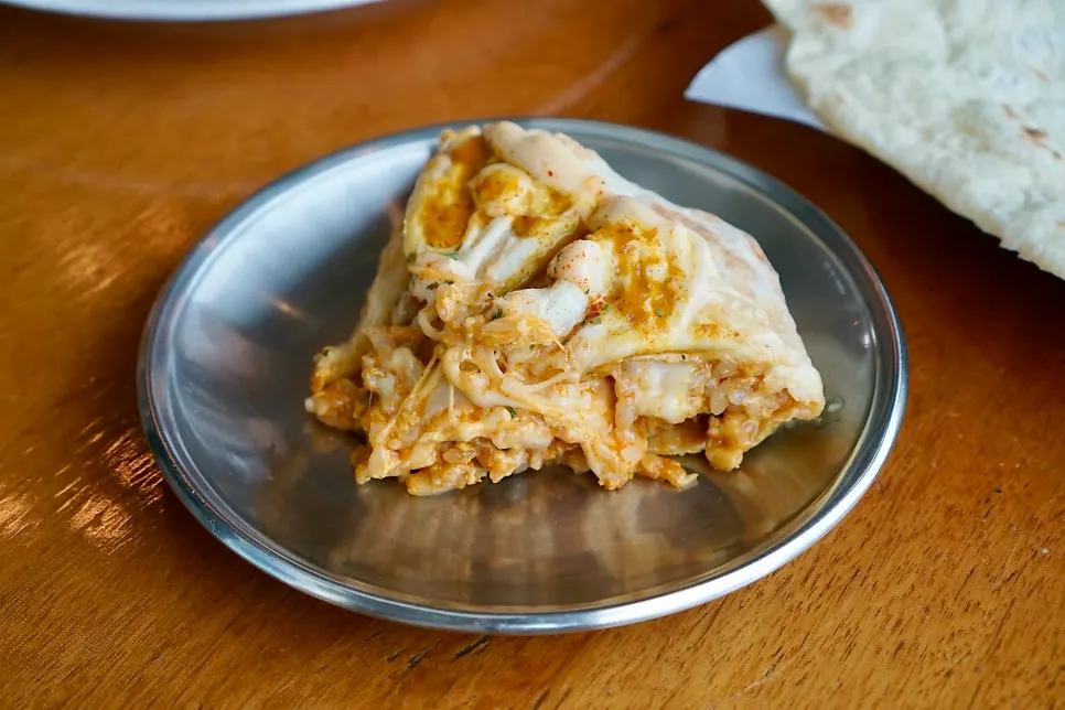 Octopus nasi goreng cut in half with cheese stretching