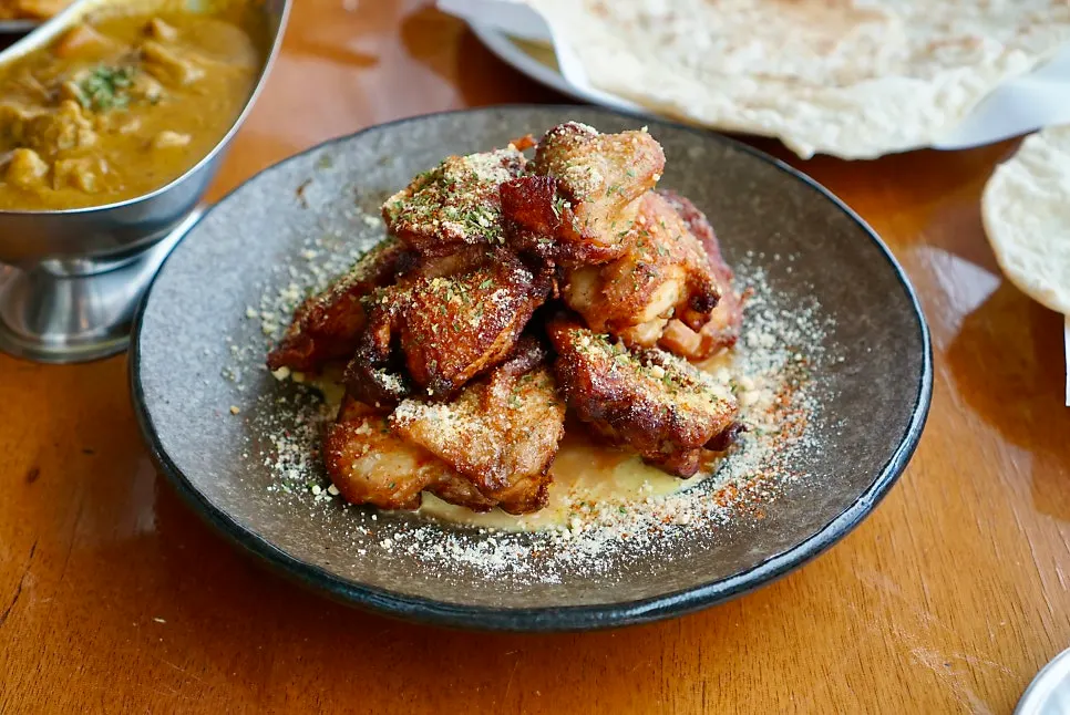 Tandoori cream chicken stacked in layers on a plate