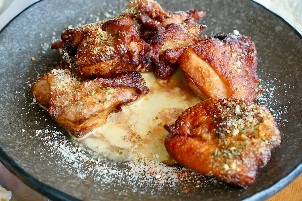 Dipping chicken into the cream sauce