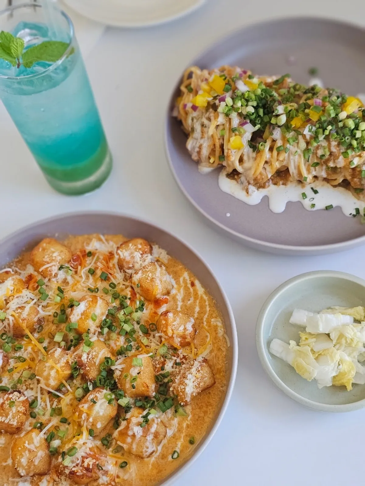 Table set with Cajun ragu pasta and gochujang cream gnocchi