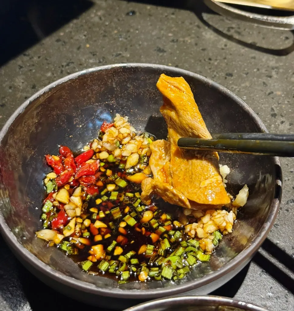 Plate of cooked meat lifted from the pot