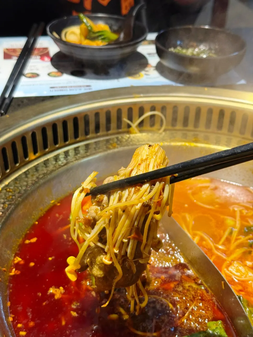Fried tofu roll lifted out of the pot