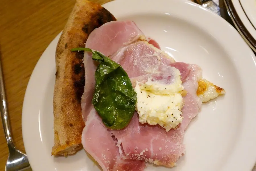 Ricotta cheese spread over the pizza
