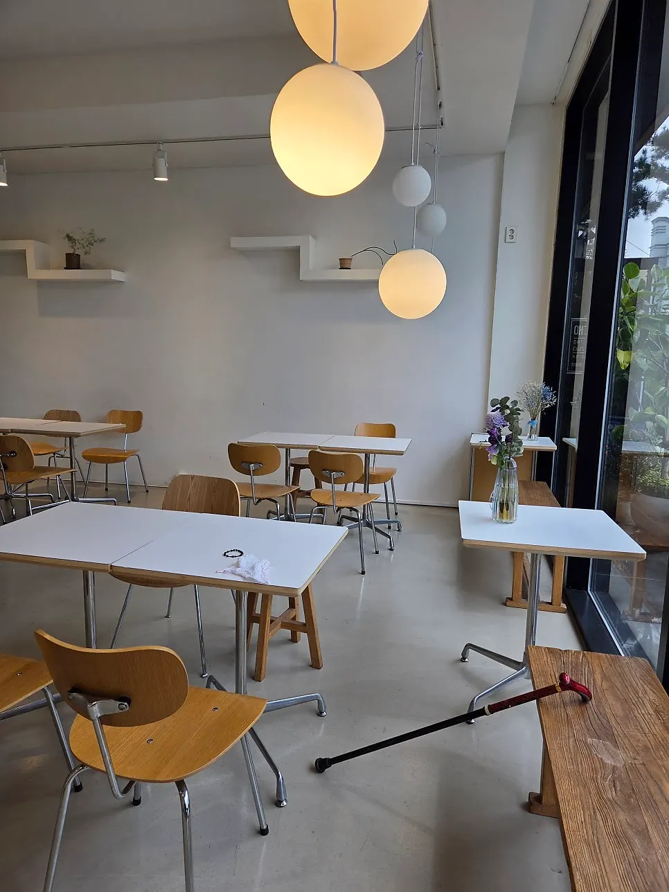 Interior of Lapins with white walls and wooden chairs