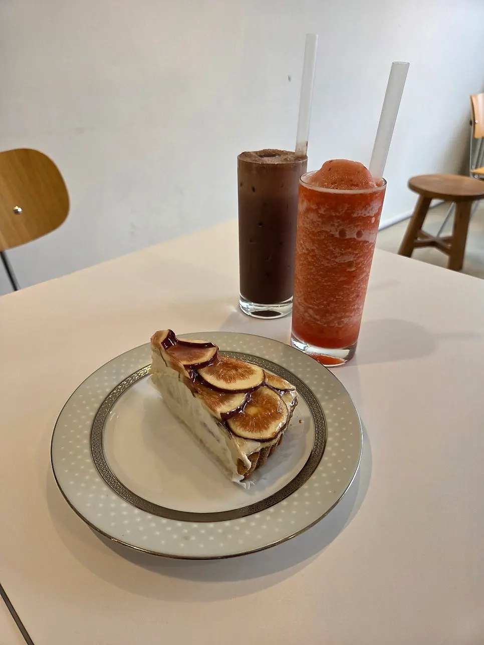 Table setting with fig earl grey tart and two drinks