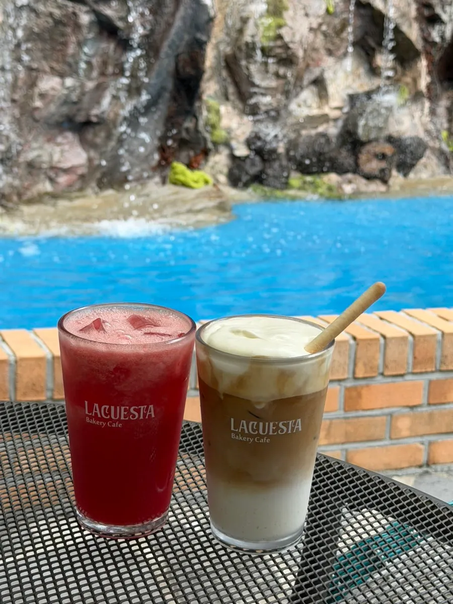 Latte and watermelon juice on an outdoor table