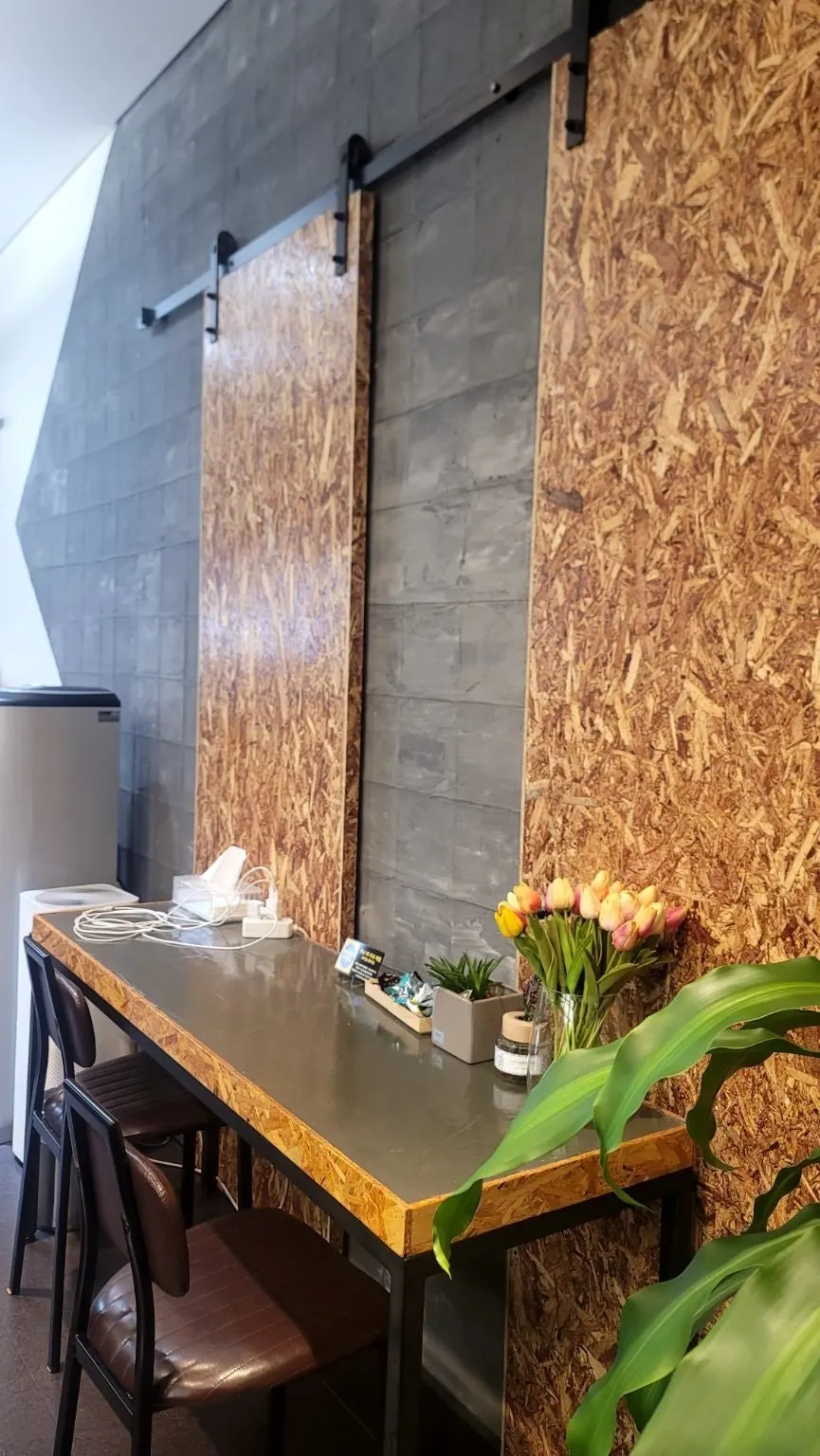 Waiting area of the eyelash salon styled like a café