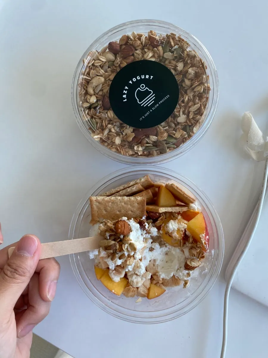 Sprinkling granola over the Cerise yogurt