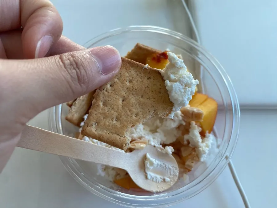 Greek yogurt finished with peach and toppings