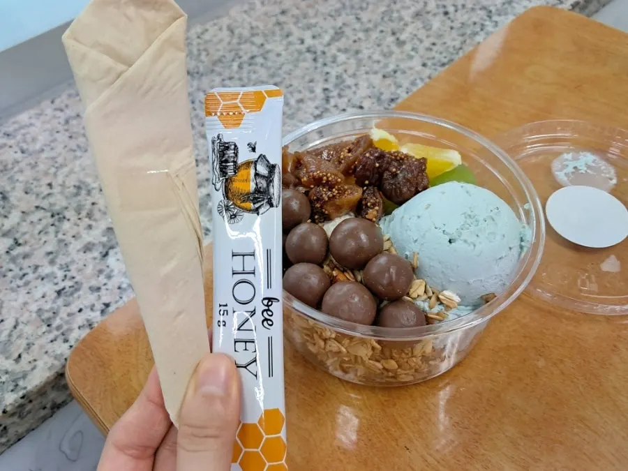 A spoonful of Greek yogurt with honey on top